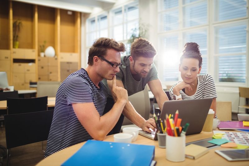 image of people looking in laptop